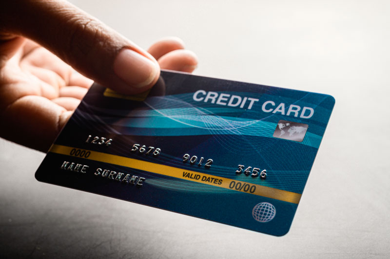 close up of hand holding credit card credit card for removing bee sting by scraping