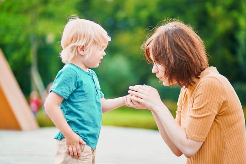 Mother comforting her son's hand, representing bee sting prevention