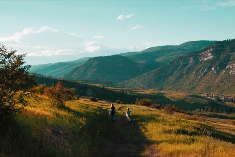 Father and son walking on path as metaphor for venom immunotherapy success story